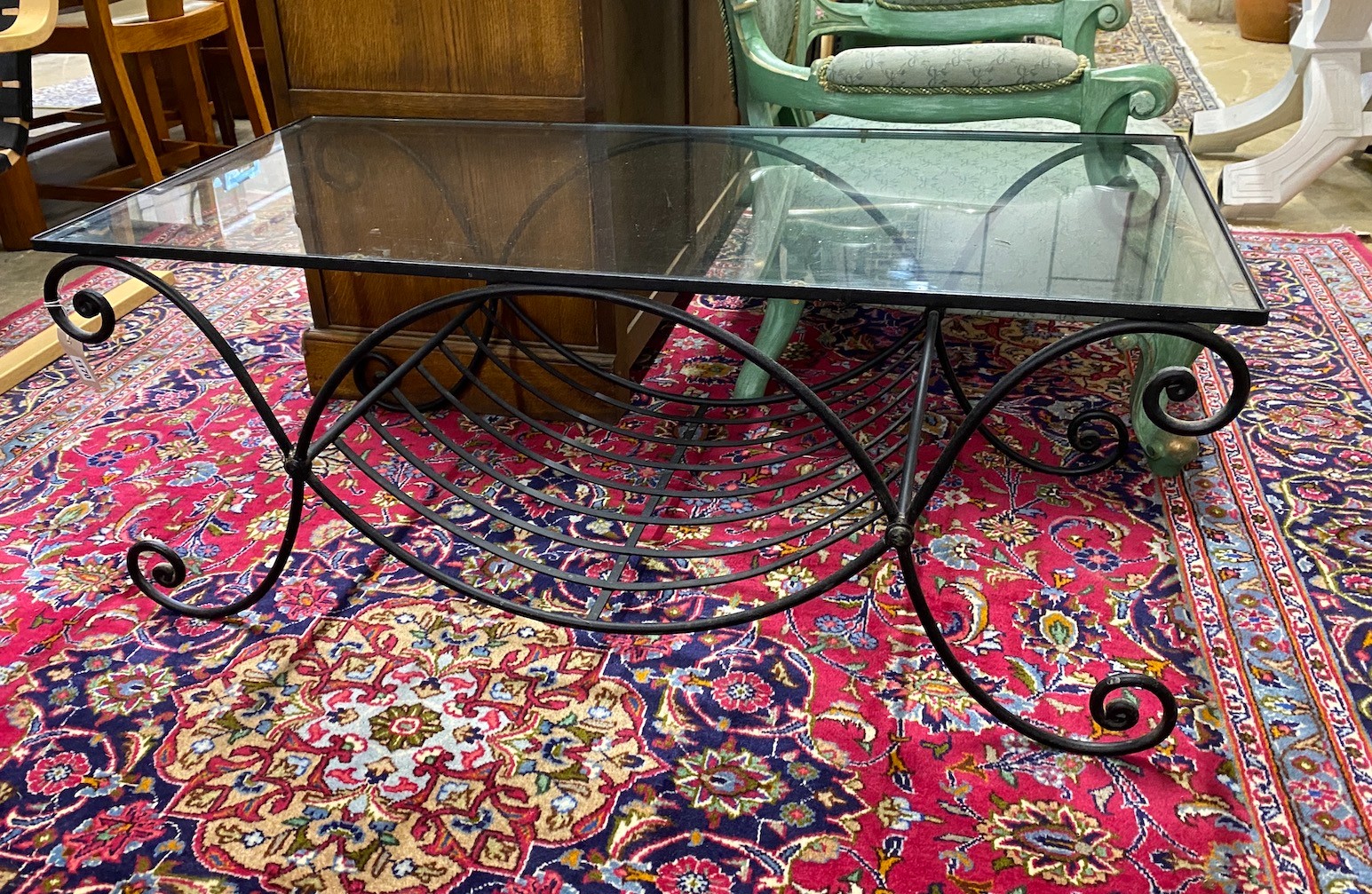 A contemporary metal and glass top rectangular wrought iron coffee table, width 110cm, depth 53cm, height 44cm